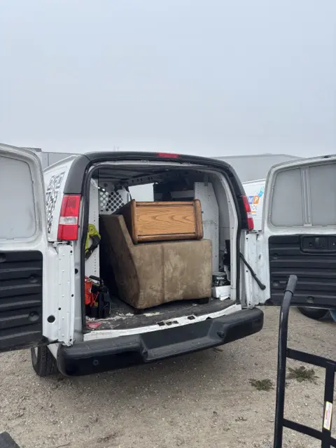 Back of van showing furniture ready for delivery.
