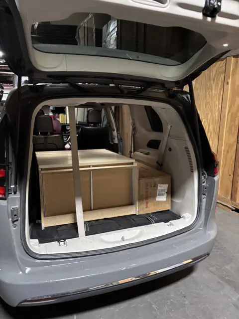 Back of SUV with furniture ready for delivery.