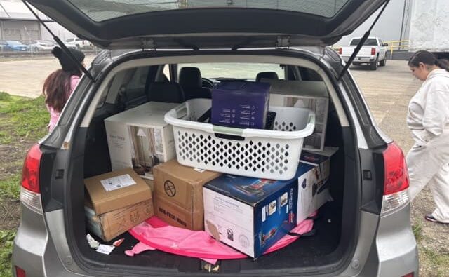 Back of SUV with household items ready for donation.