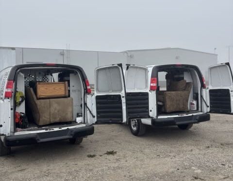 Back of 2 vans with furniture.